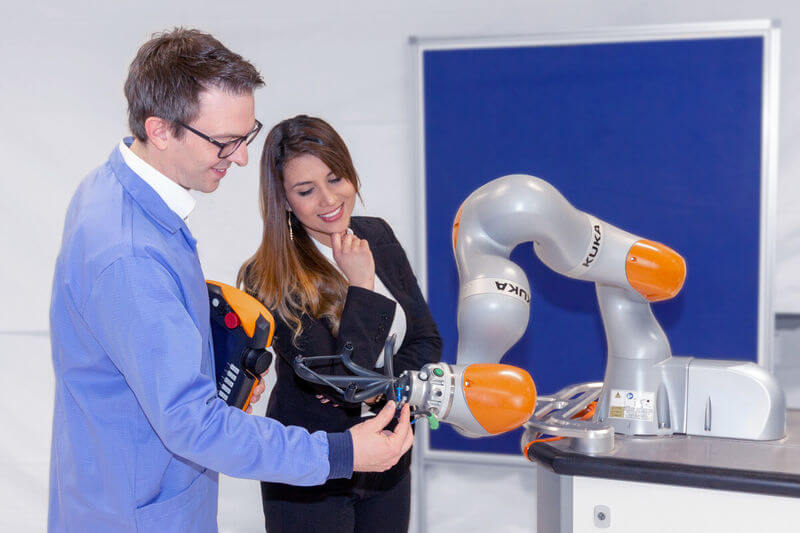 Zwei Mitarbeiter mit einem Leichtbauroboter